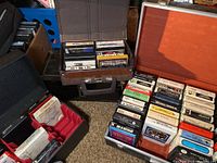 Five cases containing multiple 8 track tapes, showing the variety and number of tapes included in the lot.
