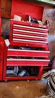 Red metal Craftsman tool chest closed showing exterior with wheels and base storage compartment