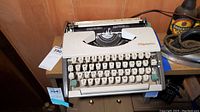 Front view of Olympia manual typewriter, showing keyboard and brand logo