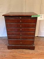 Front view of the wooden jewelry chest showing six drawers with metal pulls.