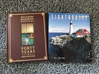 Two books on carpet - Telluride Bluegrass Festival and Lighthouses with photo covers