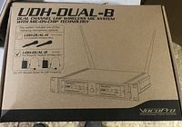 Closed retail box showing VocoPro UDH-DUAL-B dual channel UHF wireless mic system with illustration and model details on carton.