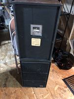 Photo showing the front and back of the stacked vintage stereo speakers with control panel and labels visible on back.