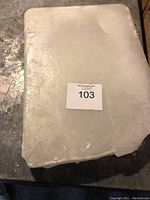 Top view of the large white wax block with smooth surface and auction label on top