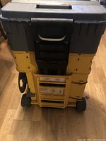 Rear view showing plastic wheels and extendable handle of Mastercraft toolbox