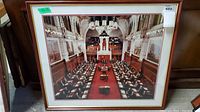 Framed photo showing Canadian Senate chamber in session, view across chamber.