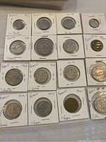 Lot of 16 French coins mainly from 1941 to 1945, organized in protective cardboard holders showing various denominations and years.