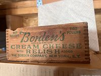 Photo showing side of wooden cream cheese carton marked Borden's with details and weight two pounds