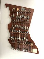 Image of entire lot including 37 collectible spoons on wooden plaque shaped like Minnesota