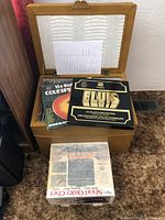 Wooden case open showing some records and boxed sets on top including Elvis Collector's Edition and The Best of Country record.