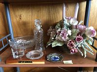 Full set on display with crystal cups, decanter, ashtray, and floral candle arrangement