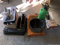 Overview of all items showing sprayer, oil pan, tarp, foam mats and painting supplies in cardboard boxes.