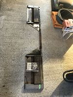 Full view of two large metal and wood alignment platforms on concrete floor showing condition and size.