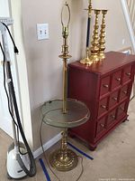 Full view of tall brass floor lamp with glass tray and no lampshade