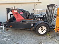 Side view of Toro mini skid steer loaded on trailer deck