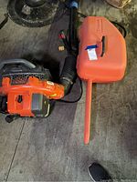 Orange chainsaw case and leaf blower tube
