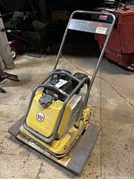 Front-right perspective showing compactor resting on furniture mover board