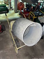Full view of mixer angled left showing frame, drum, wheels and motor