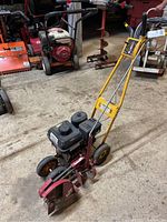 Overall front angled view of gas-powered walk-behind edger showing blade housing and handle