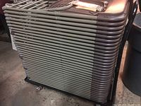 Side view of stacked folding chairs on wheeled cart