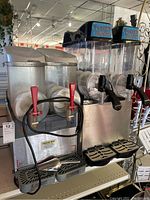 Front view of two machines side by side on shelf