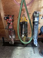 Front view of all three jackhammers mounted on rack