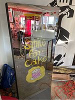 Front mirrored surface with “smile for cake” decal overlay