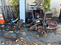 Overview of trencher attachment at left and auger bits with gas engine at center