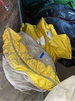 Folded beige and yellow fabric tents stacked