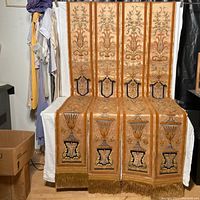 Four antique silk drapery end panels displayed seated, showing full length and detailed motifs