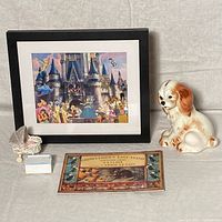 Full lot from front showing framed Disney print with pins, terrier bank, doll furniture, and book
