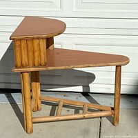 Side angled view showing bamboo frame and Formica surface on two tiers with corner shape.