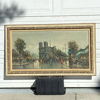 Overall front view of framed painting showing Notre Dame street scene and carved gilt wood frame