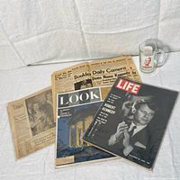Full lot view showing mug, LIFE magazine, LOOK magazine, and newspapers.