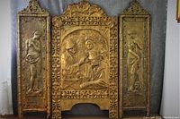 Three brass repoussé wall panels: two narrow side panels featuring female figures and central panel with group of figures in classical attire