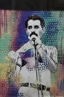 Close-up photo of colorful offset silkscreen art featuring Freddy Mercury singing on a microphone.
