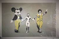 Gray background offset print showing Mickey Mouse, naked girl, Ronald McDonald in a row