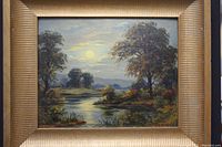 Front view of oil painting in gold-tone wooden frame showing river scene under sun, trees and hills