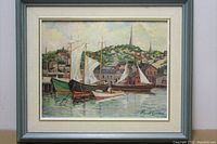 Front view of framed oil painting depicting sailboats and waterfront with hills in background, signed by Paul Ernest Wilke.