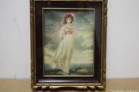 Front view of framed Thomas Lawrence print titled 'Pinkey' showing a young girl in a white dress and pink bonnet in a natural outdoor setting against a cloudy sky.