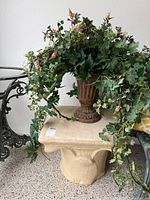 Wide view of stone table with floral arrangement on top
