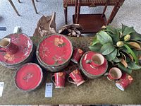 Full view of over 30 pieces of Tracy Porter floral dinnerware including plates and mugs with accompanying artificial floral arrangements.