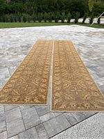 Two matching runners laid side by side on paver surface