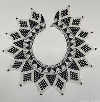 Full view of the black and white beaded necklace showing triangular and diamond shapes arrangement