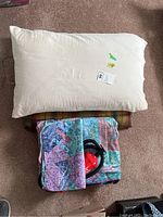 Image showing the white pillow, decorative plaid pillow, and folded air mattress with fabric