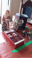 Image showing large Santa figure, Sarah's Angel Bedtime Prayer figurine, musical water globe in box, and four Christmas cheese spreaders with character handles.