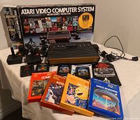 Overview of original Atari box, 2600 console, controllers, games, manual and cables