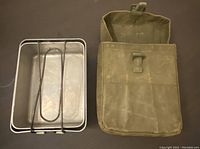 Closed mess tin alongside canvas carry pouch showing front buckle closure