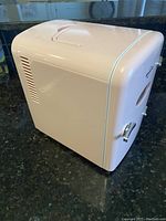 Side view of the Koolatron mini fridge showing the vent and light pink color