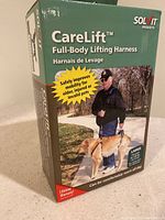 Box of Solvit CareLift full-body lifting harness showing brand, product name, and usage image with man lifting a dog.